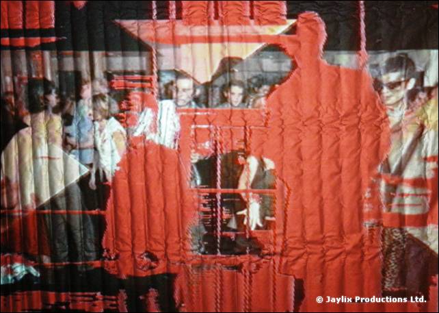 A rippled red screen showing a projected crowd with a large red silhouette