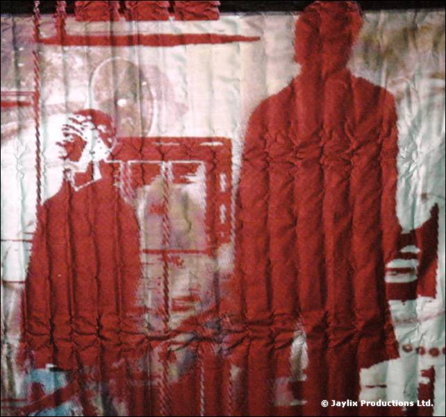 Red and white printed fabric backdrop showing two standing silhouetted figures