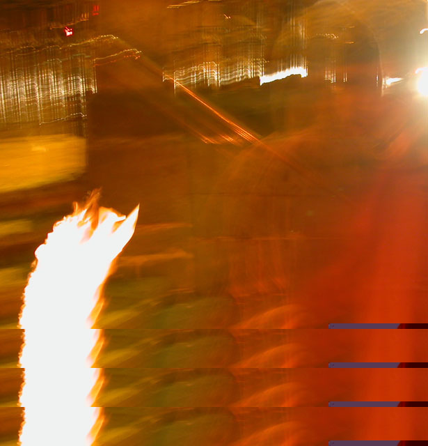 A blurred tall flame in a dark room with horizontal grey bars across the lower part