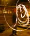 A tiny blurred image of a circle of fire on a dark background