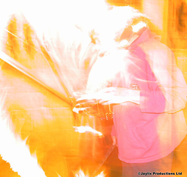 An overexposed blur of white and orange light with a figure in a pink top