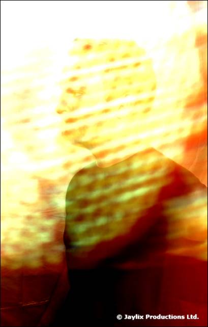 An overexposed blur of a person behind a glowing yellow light