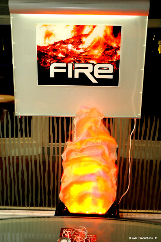 A glowing orange fire-shaped light sits beneath a backlit FIRE sign showing flames