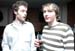 Very small image of two people standing side by side, one in white and one in a striped top
