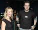 A woman and a man standing side by side in a dark room