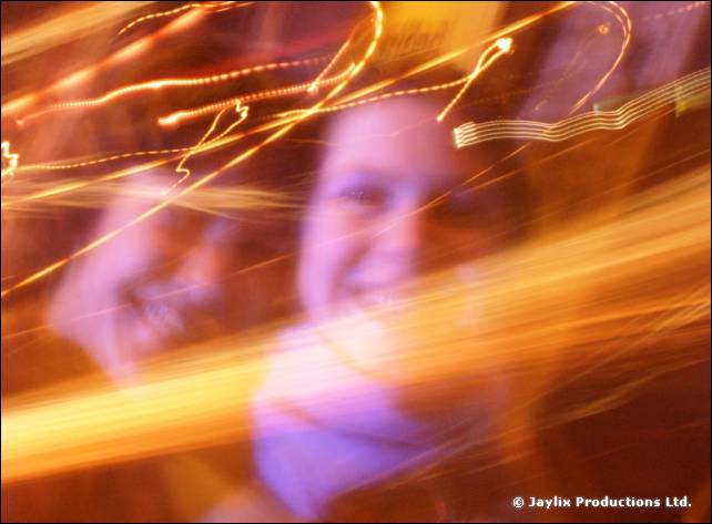 Abstract blurred light trails streaking across a smiling face