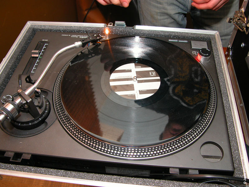 A record on a turntable in a silver flight case