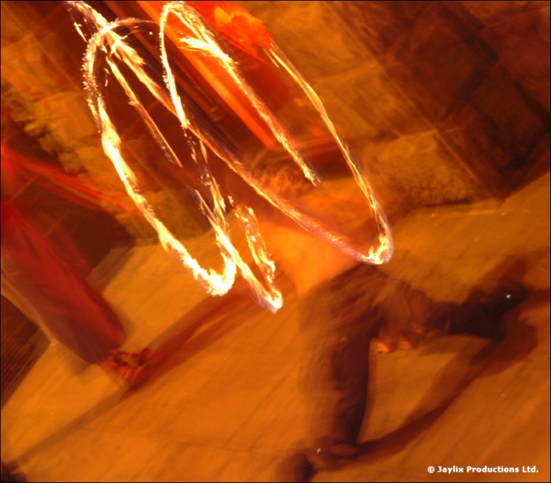 Blurred rings of fire above a stone pavement at night
