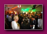 Small framed thumbnail of a crowded room with green light and people standing
