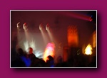 Small framed thumbnail of a dark club with spotlights and orange flame effects