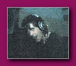 Small grainy thumbnail of a person wearing headphones