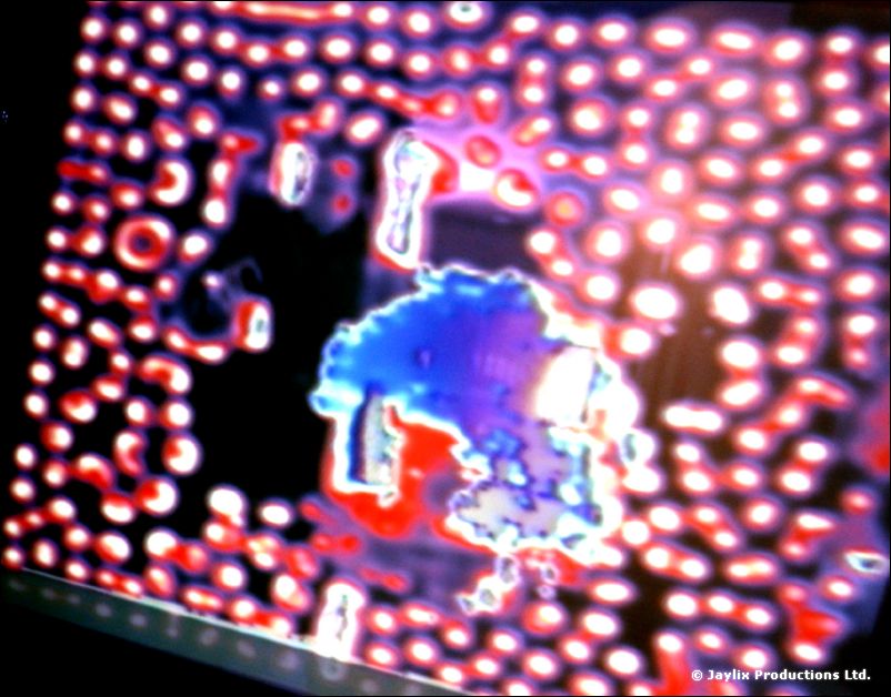Projected video image of pixelated red and blue dots on a screen