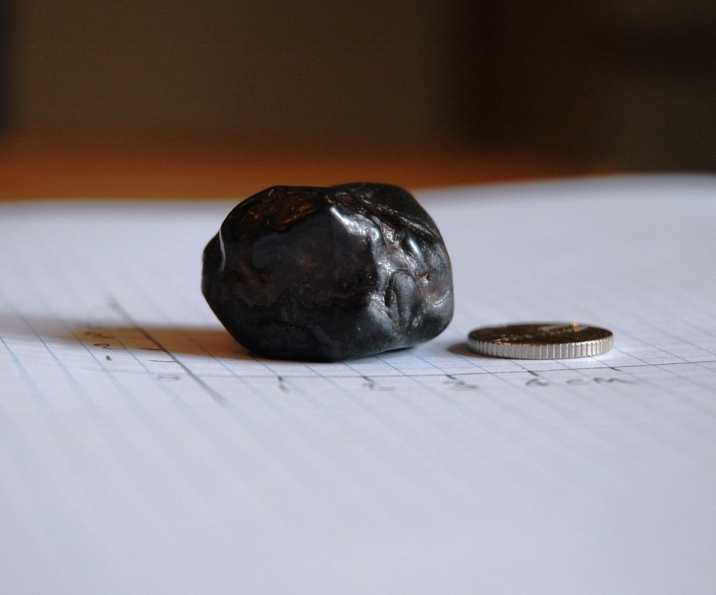 elation view of object on graph paper with 5p coin for scale
