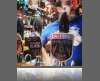 A very small thumbnail of a person in blue shirt in front of bar taps