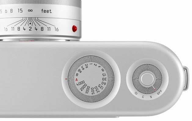Close-up of the top of a silver Leica camera showing the focus scale and dials