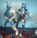 Two Star Wars bounty hunter action figures in armour, posed on a shelf