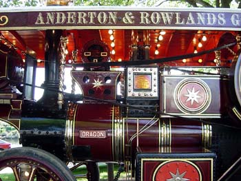 Close-up of a red and gold steam engine with a Dragon nameplate and Anderton and Rowlands lettering