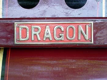 Close-up of a metal nameplate reading Dragon on a red panel
