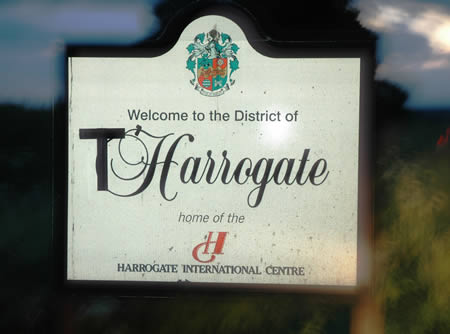Sign reading 'Welcome to the District of Harrogate, home of the Harrogate International Centre'
