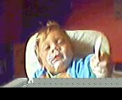 baby in high chair with food over their face