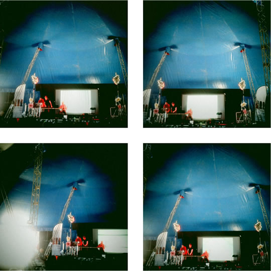 Four photos of the inside of a blue big-top tent with a stage, screen and lighting towers