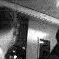 A dark doorway and a person's head, black-and-white