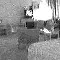 A living room with a television and armchairs, black-and-white