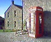 Stone house next to a red telephone box