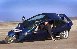 Small distant photo of a dark trike on a sandy surface